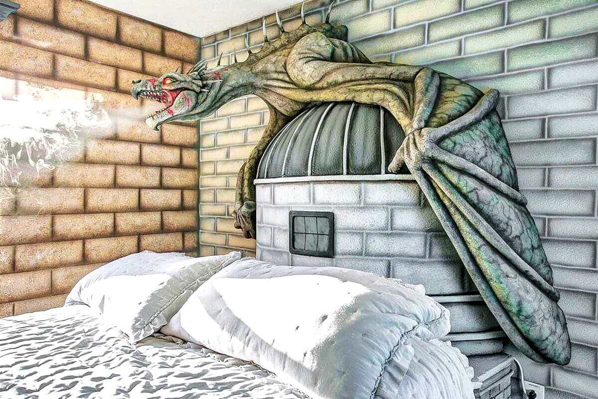 Up close a dragon inspired by the Gringotts Ukrainian Ironbelly fills the wall — scaled wings spread