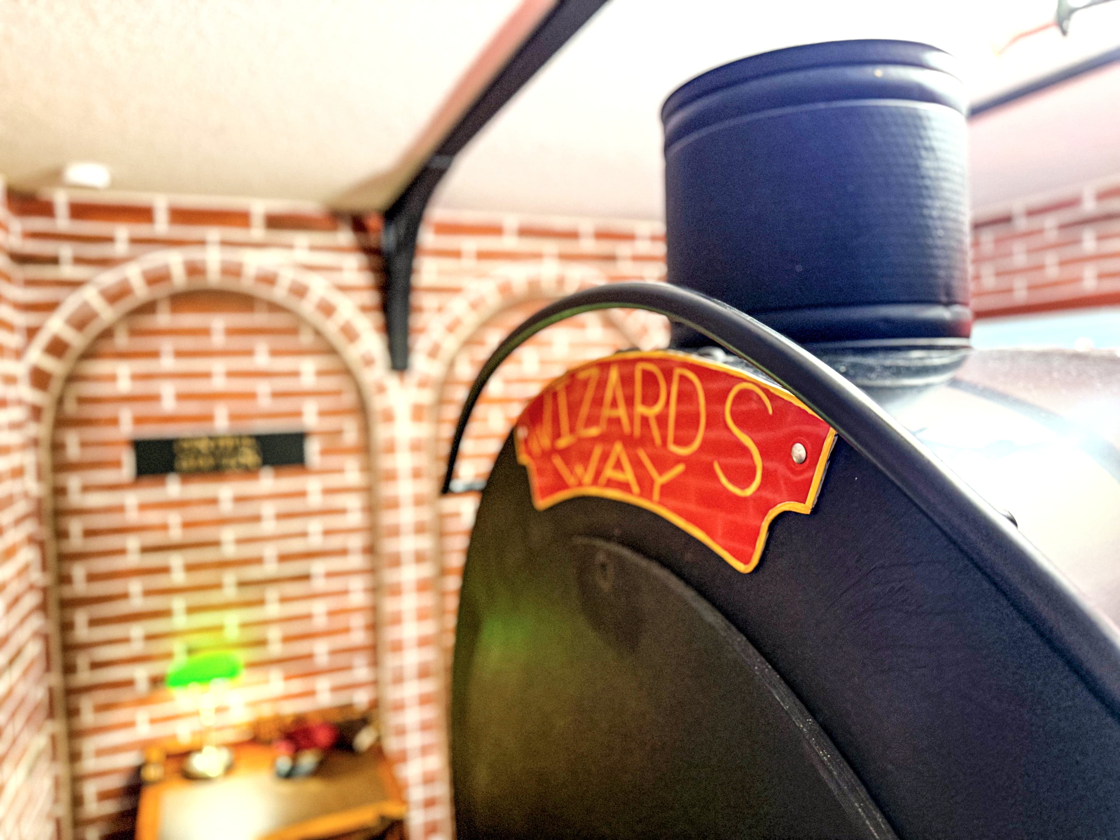 Red and gold. Wizard’s Way on the locomotive nose, King’s Cross brick archway gl