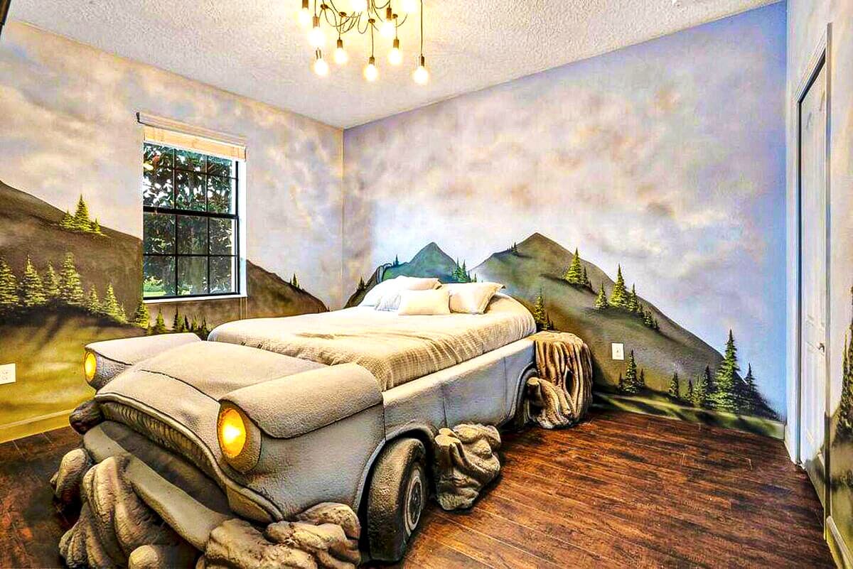 Cloud murals floor to ceiling — and a life-sized Ford Anglia hovering right in t