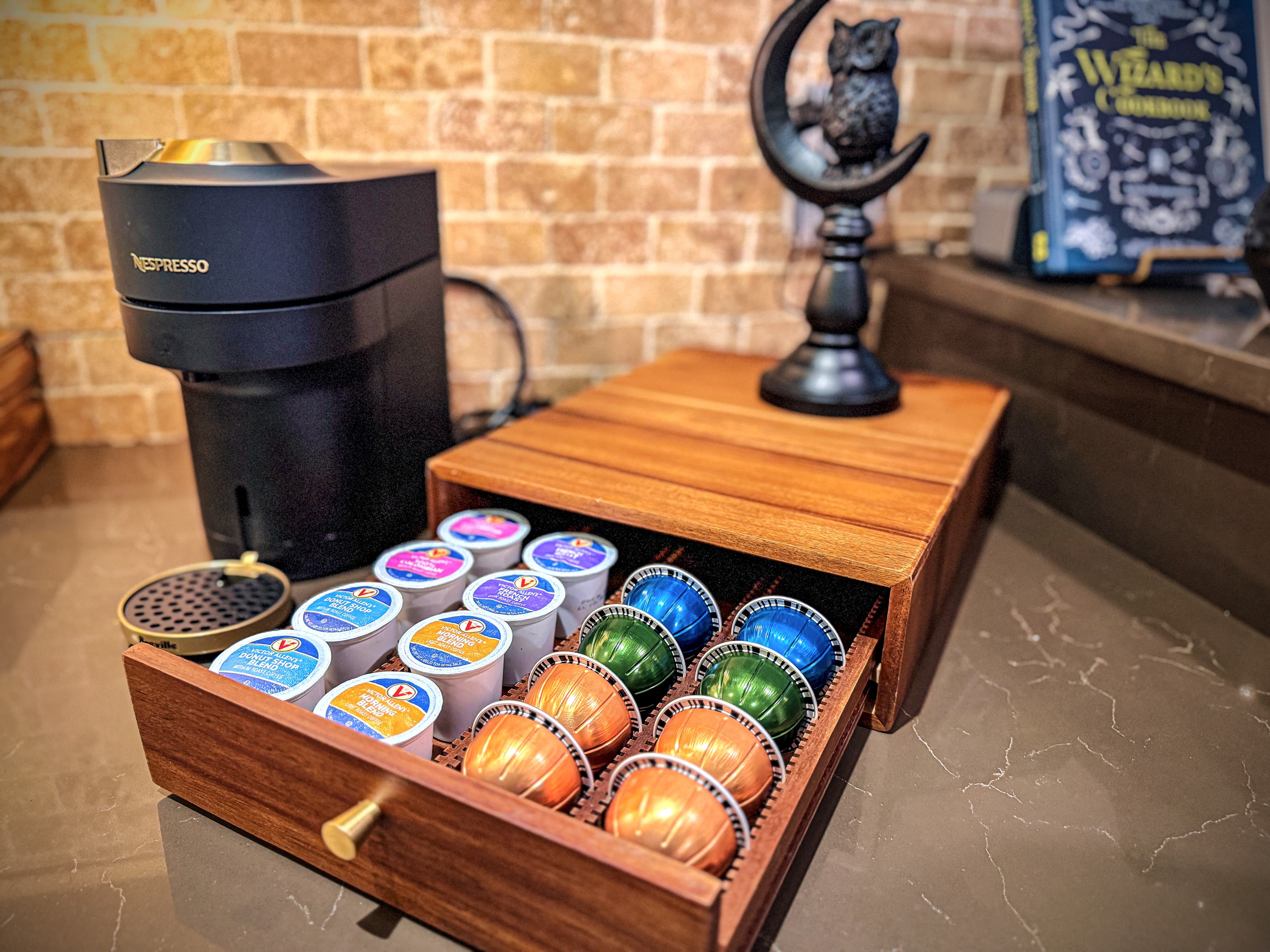 Nespresso Vertuo loaded, walnut drawer stocked with colorful pods, a cauldron-sh