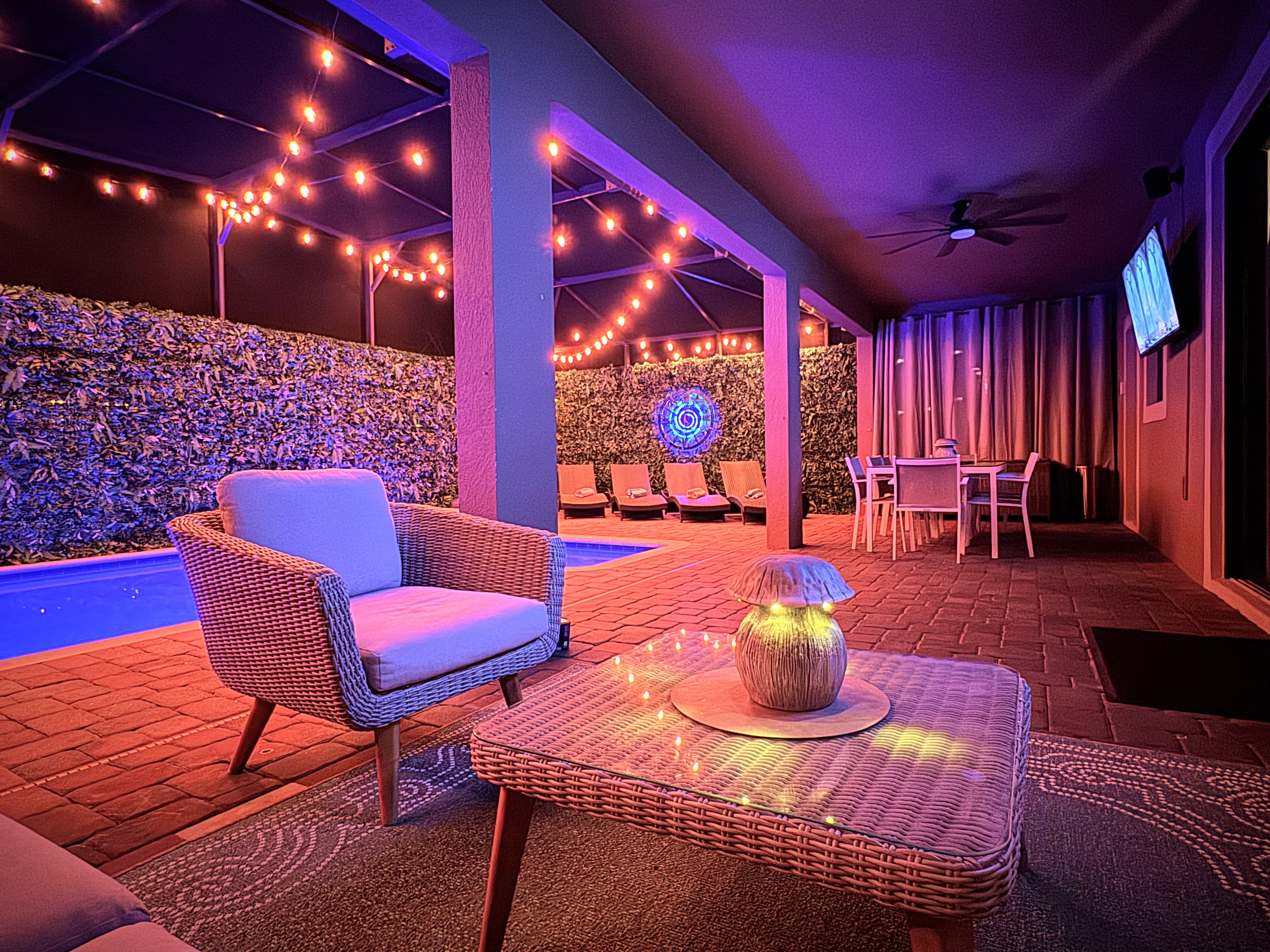 Wine on the lanai while the pool glows purple and the string lights hum. This is