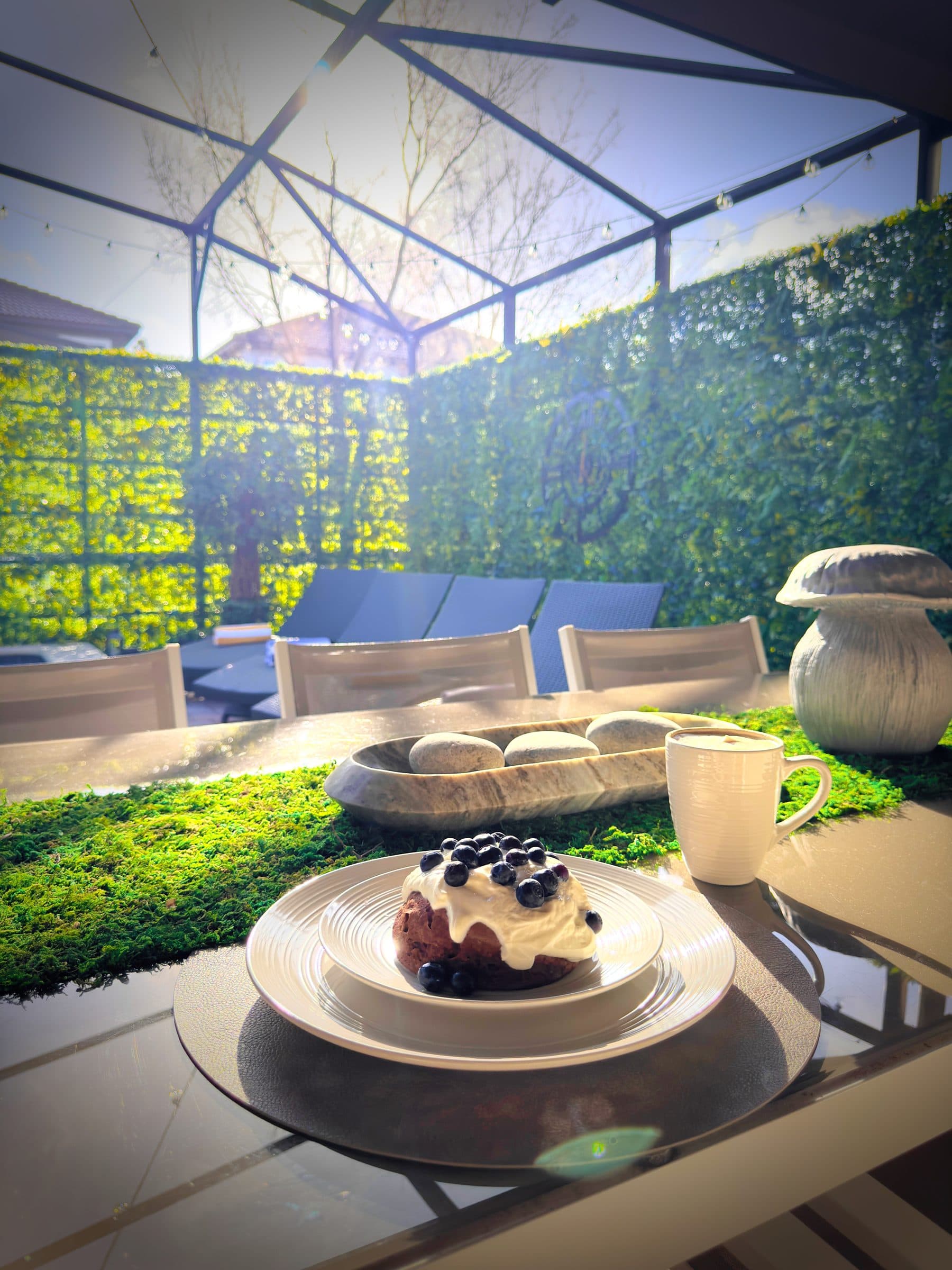 Brunch poolside with warm sun filtering through the screen. Golden light, nowher