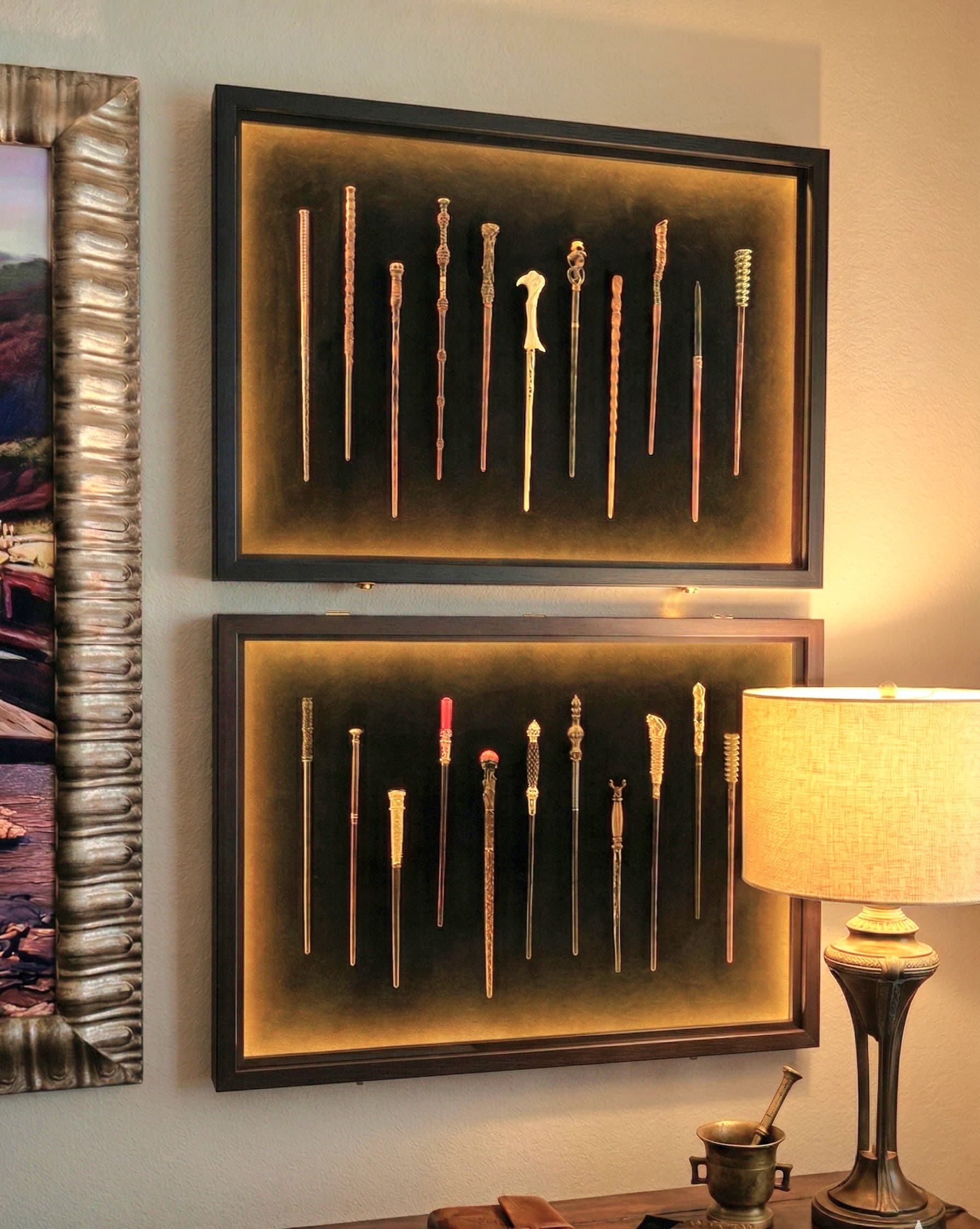 Two LED-lit shadow boxes display a curated collection of character wands that sh