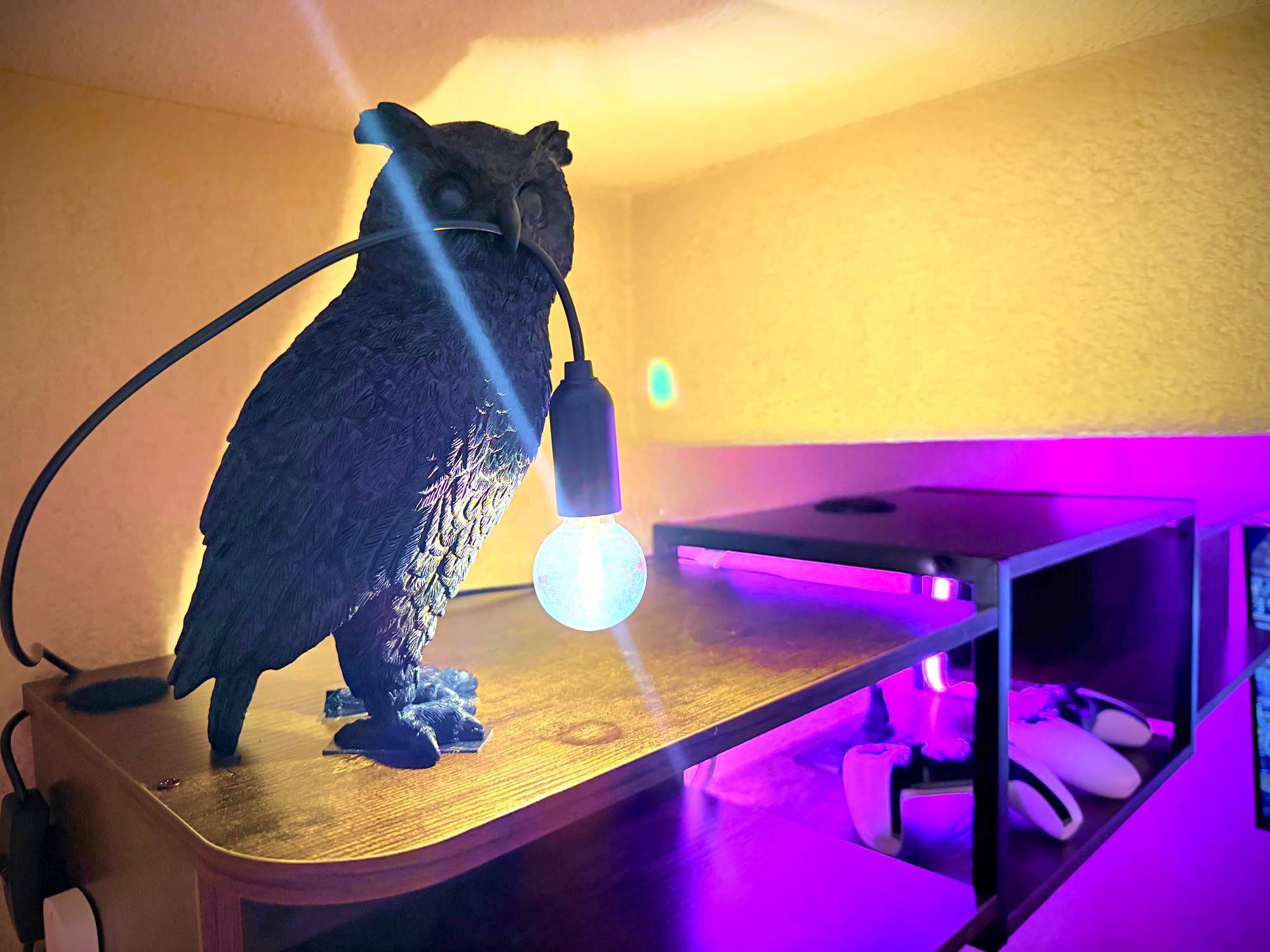 Inside the cupboard inspired by Harry's — a sculpted snowy owl lamp clutching a glowing bulb, pu