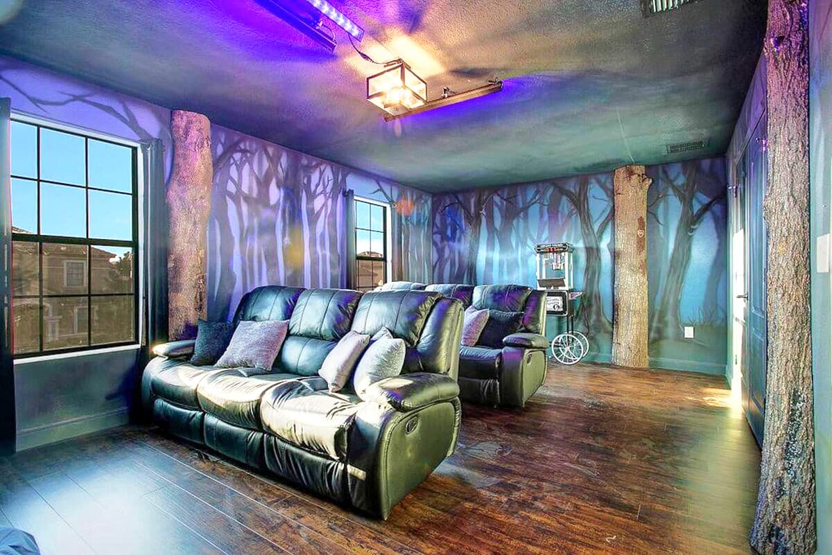 Lights on — enchanted forest murals, eight leather recliners, LG 85' 4K OLED, re